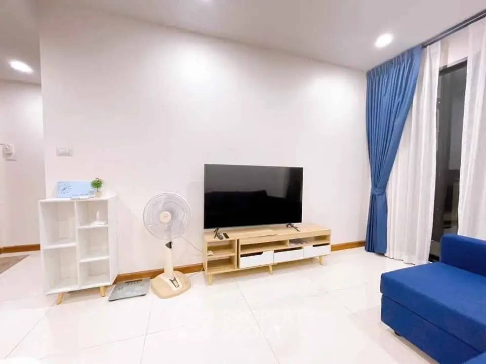 Modern living room with sleek TV setup and stylish blue curtains