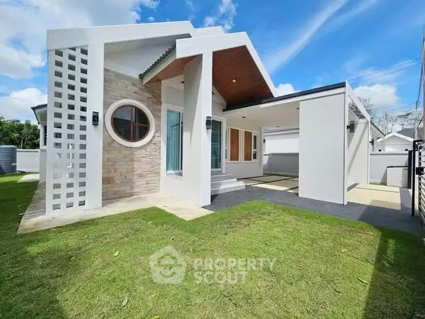 Modern single-story house with unique architecture and spacious lawn