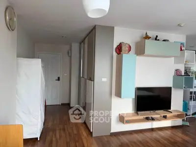 Modern living room with sleek wooden flooring and stylish TV unit