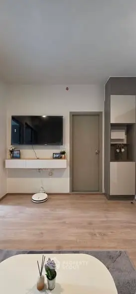 Modern living room with wall-mounted TV and minimalist decor