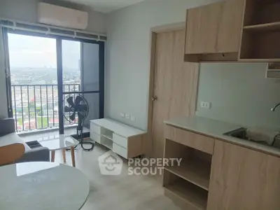 Modern apartment interior with balcony view, featuring sleek kitchen and stylish living area.