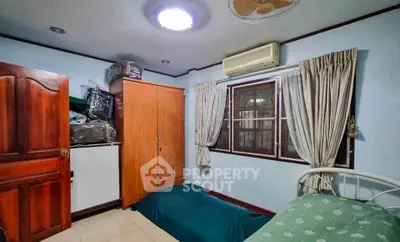 Cozy bedroom with air conditioning and ample storage in a serene setting.