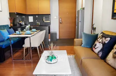 Modern living room with stylish decor and open kitchen layout, featuring cozy seating and elegant dining area.