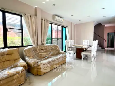 Spacious living room with elegant dining area and natural light