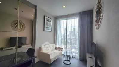 Modern living room with large window and stylish decor in urban apartment.