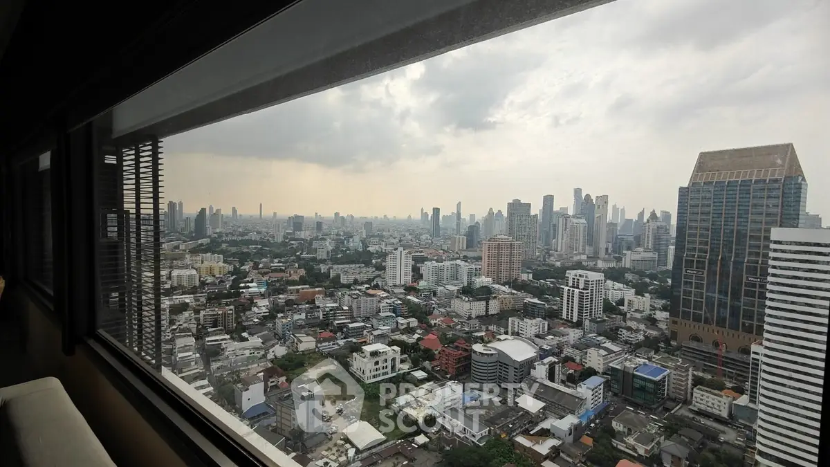 Stunning cityscape view from high-rise building window showcasing urban skyline.