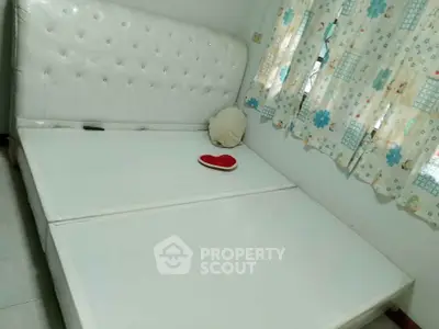 Spacious bedroom with elegant white bed and floral curtains