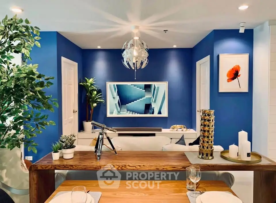 Stylish modern living room with blue accent wall and elegant decor