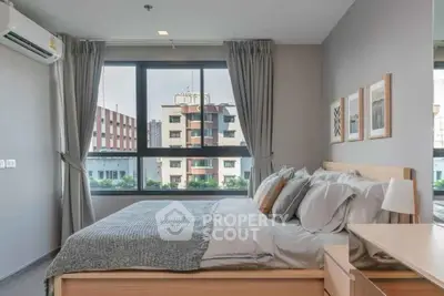 Modern bedroom with large window and stylish decor in urban apartment