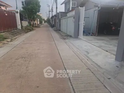 Quiet residential street with houses and garages in suburban neighborhood
