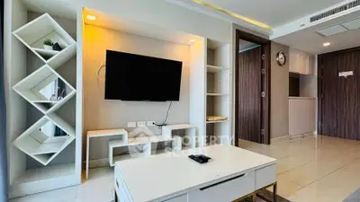 Modern living room with sleek TV setup and stylish shelving