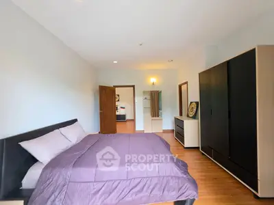 Spacious bedroom with modern furnishings and ample natural light
