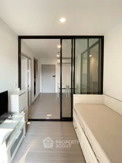 Modern studio apartment with glass partition and sleek interior design