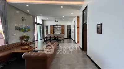Spacious modern living room with elegant furniture and open dining area, perfect for entertaining.