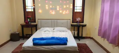 Cozy bedroom with ambient lighting and comfortable bed, perfect for relaxation.