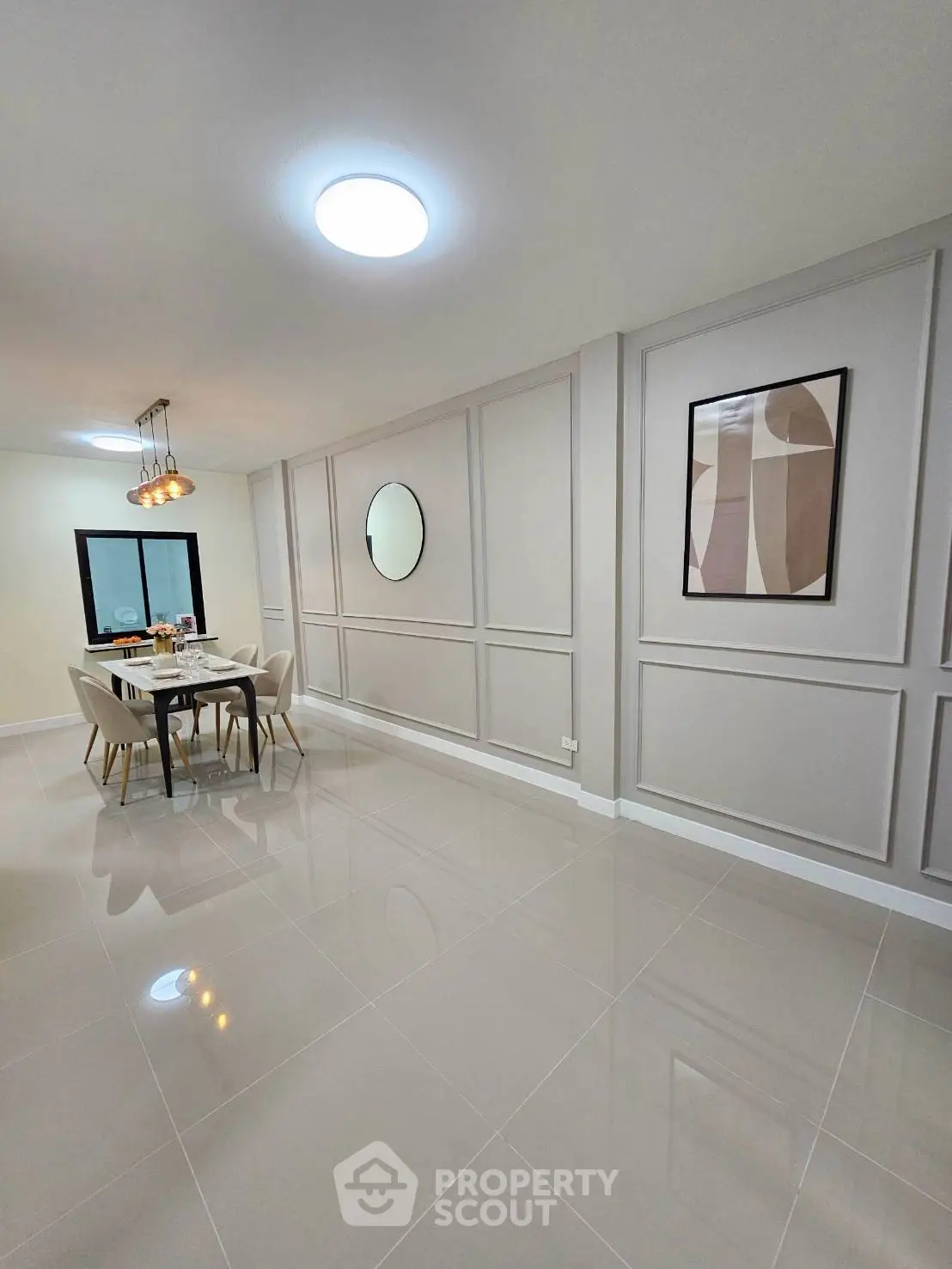 Elegant dining area with modern decor and stylish lighting in a spacious open layout.