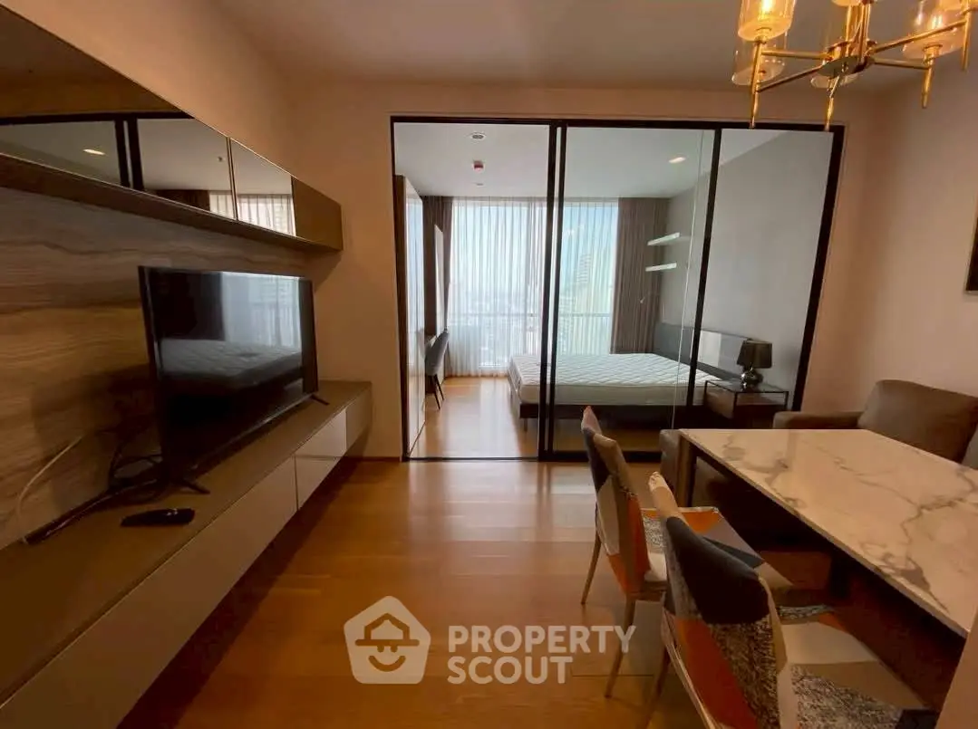 Modern apartment with open living and bedroom area, stylish furniture, and natural light.