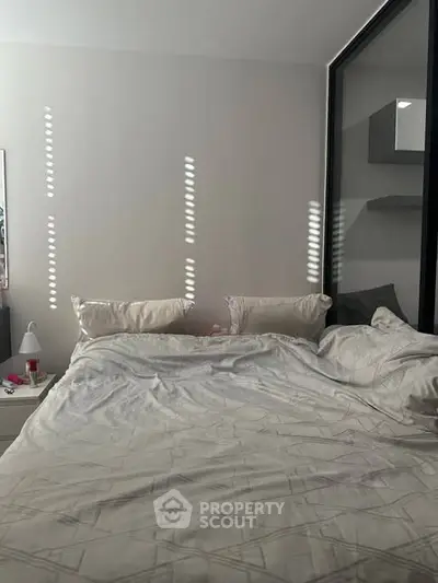 Cozy bedroom with modern decor and ample natural light