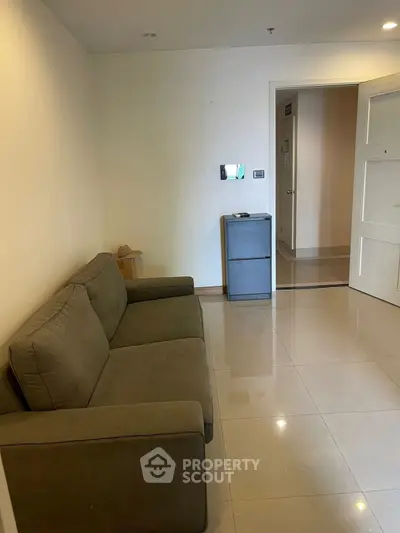 Cozy living room with modern sofa and sleek tiled flooring