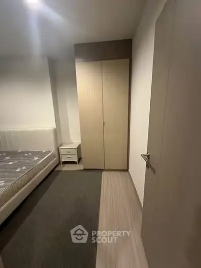 Cozy bedroom with modern wardrobe and comfortable bed in a stylish apartment.