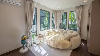 Cozy living room with large windows and plush seating area