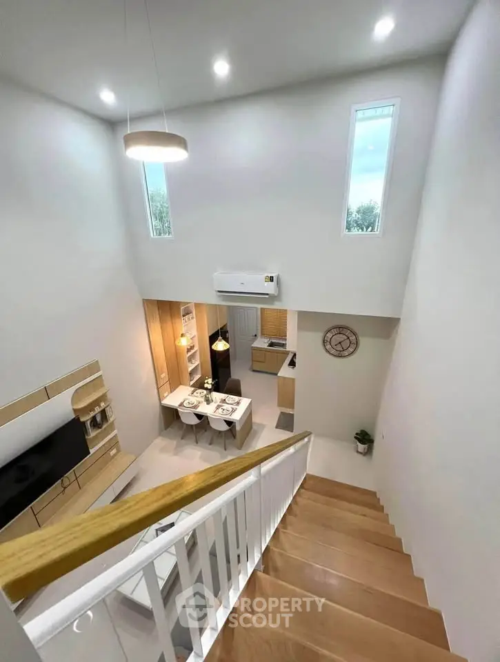 Modern open-plan living area with high ceilings and stylish kitchen