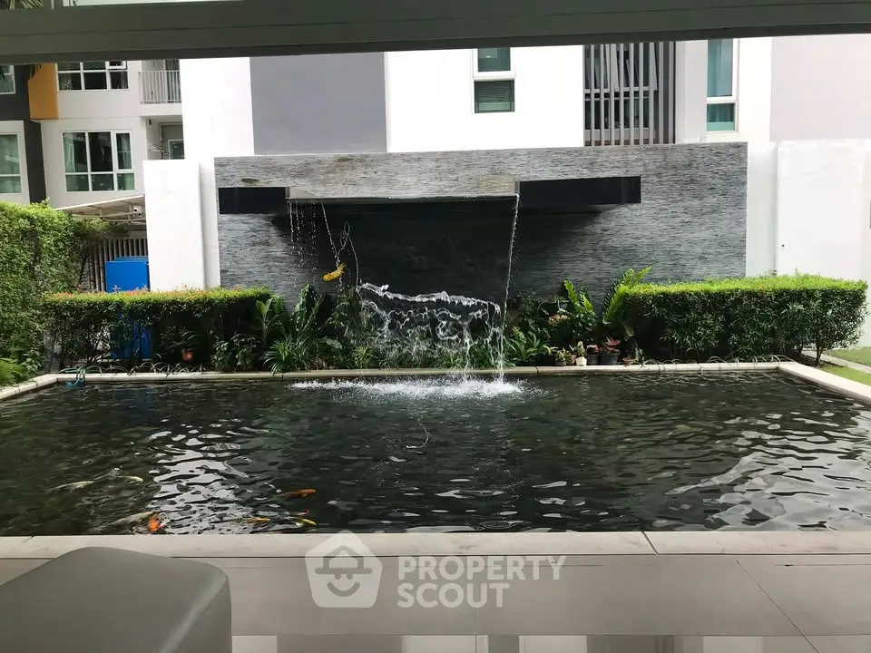 Luxurious apartment complex with serene koi pond and modern architecture