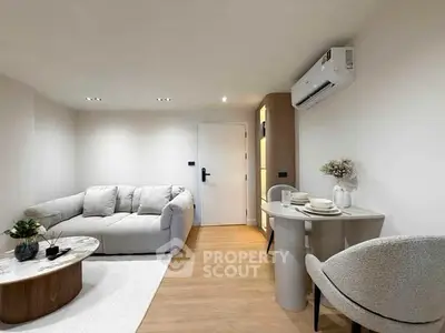 Modern living room with cozy sofa, stylish table, and air conditioning in a bright apartment.