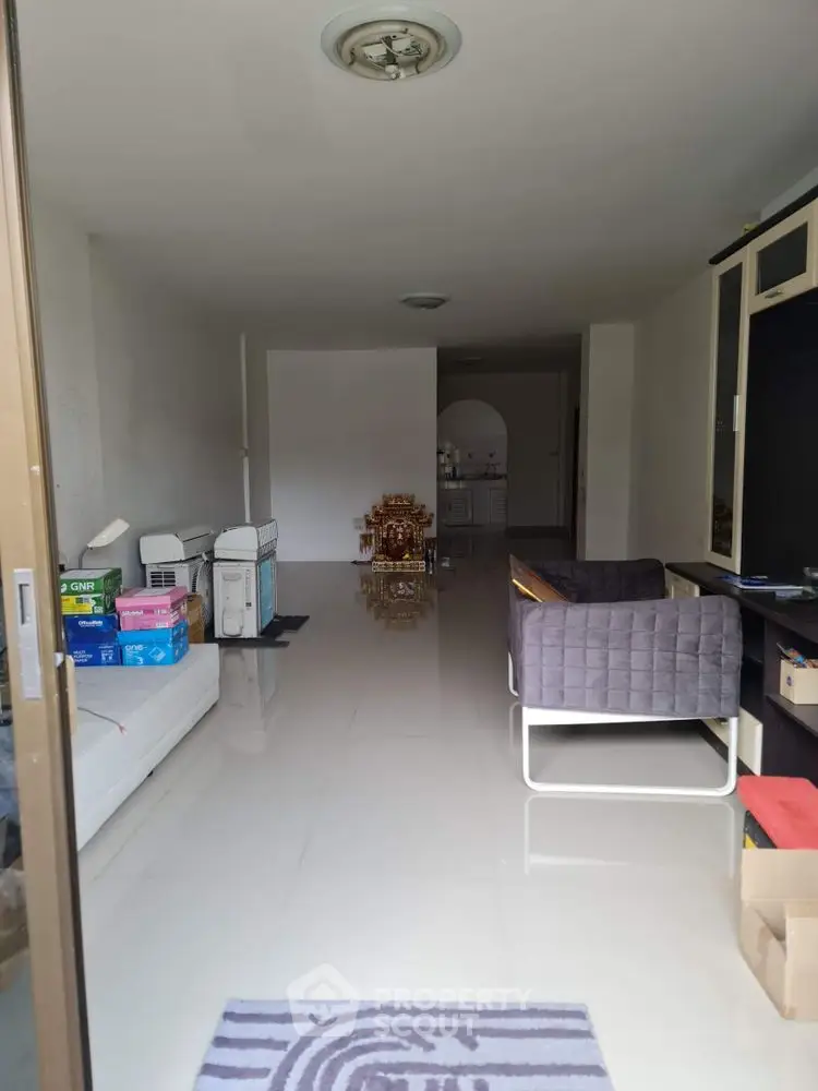 Spacious living room with modern furniture and glossy tiled flooring