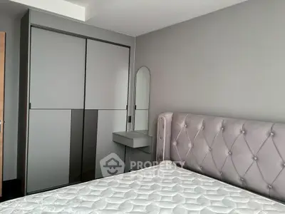 Modern bedroom with stylish wardrobe and elegant upholstered bed.