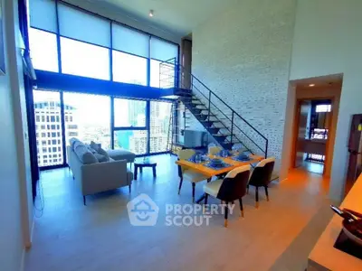 Stunning modern living room with high ceilings and city view, featuring elegant dining area and stylish staircase.
