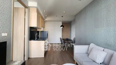 Modern open-plan living room with stylish decor and dining area in a contemporary apartment.