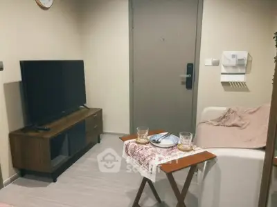 Cozy living room with modern TV stand and comfortable seating, perfect for relaxation.