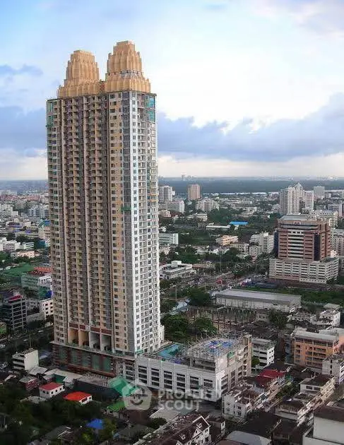 Stunning high-rise building with unique architectural design in bustling cityscape.