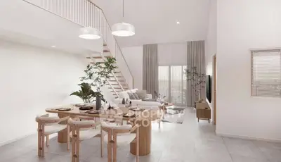Spacious modern living room with dining area and staircase, featuring elegant decor and natural light.