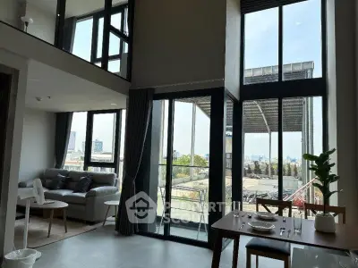Spacious modern living room with large windows and balcony view