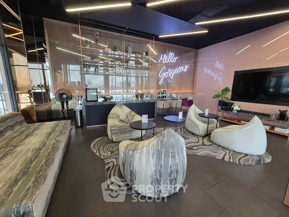 Modern living room with stylish furniture and neon sign, perfect for relaxation and entertainment.