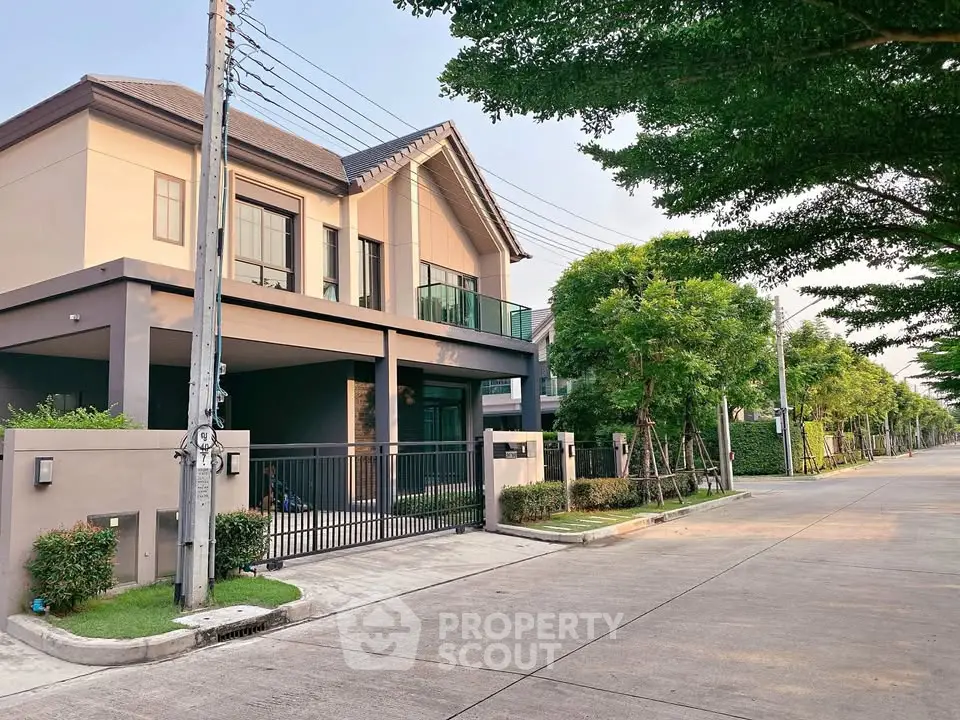 Modern two-story house with spacious driveway and lush greenery in a serene neighborhood.