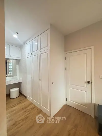 Modern bedroom with built-in wardrobe and wooden flooring