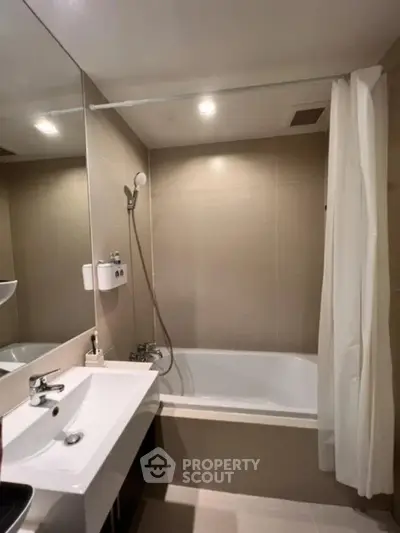 Modern bathroom with bathtub and sleek fixtures in a contemporary apartment.