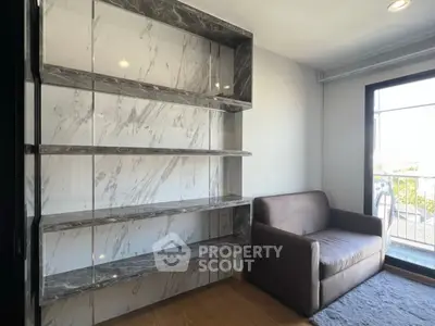 Modern living room with marble shelves and cozy sofa near balcony