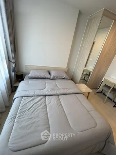 Cozy bedroom with modern decor and ample natural light