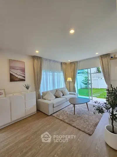 Bright and cozy living room with modern decor and garden view
