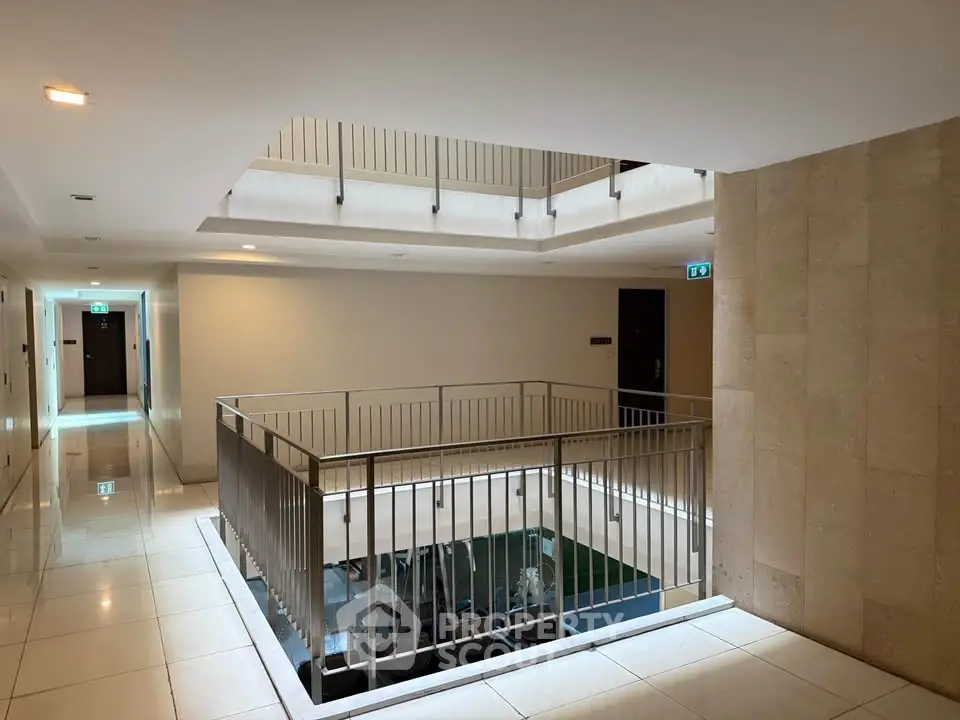 Modern apartment building corridor with sleek design and natural lighting