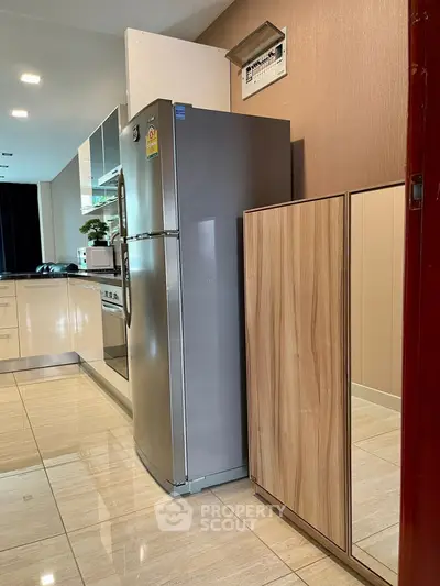 Modern kitchen with stainless steel fridge and sleek cabinetry