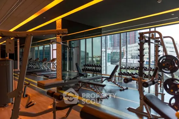 Modern gym with state-of-the-art equipment and city view in luxury residential building.