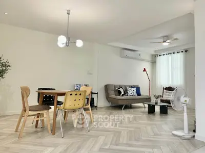 Spacious modern living room with stylish decor and ample natural light.