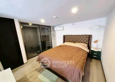 Modern bedroom with stylish bed and glass partition in cozy apartment