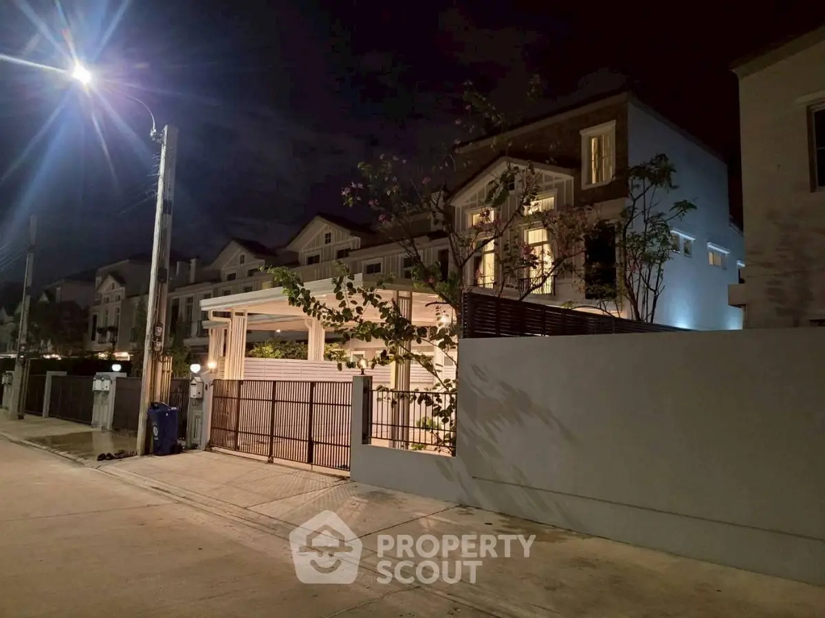 Charming night view of a modern residential neighborhood with well-lit streets and elegant homes.