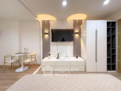 Modern studio apartment with stylish decor and open layout, featuring a cozy dining area and sleek storage solutions.